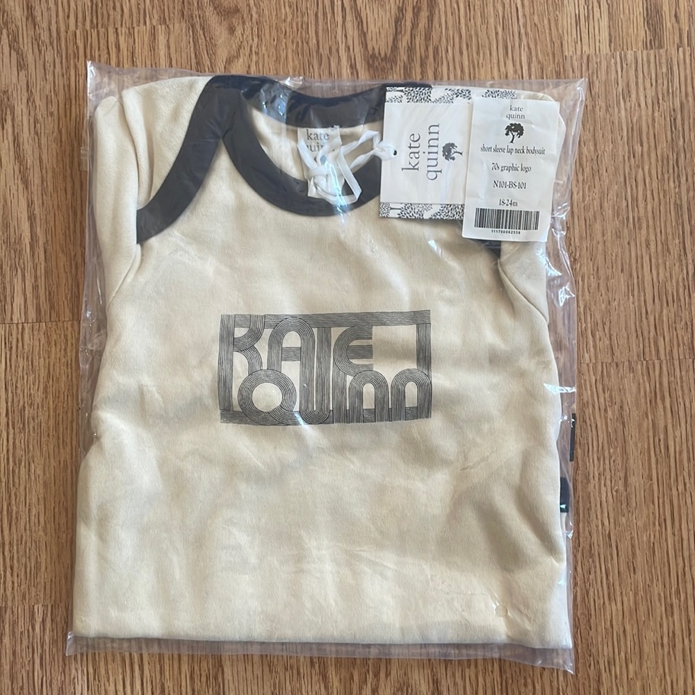 Kate Quinn logo onesie